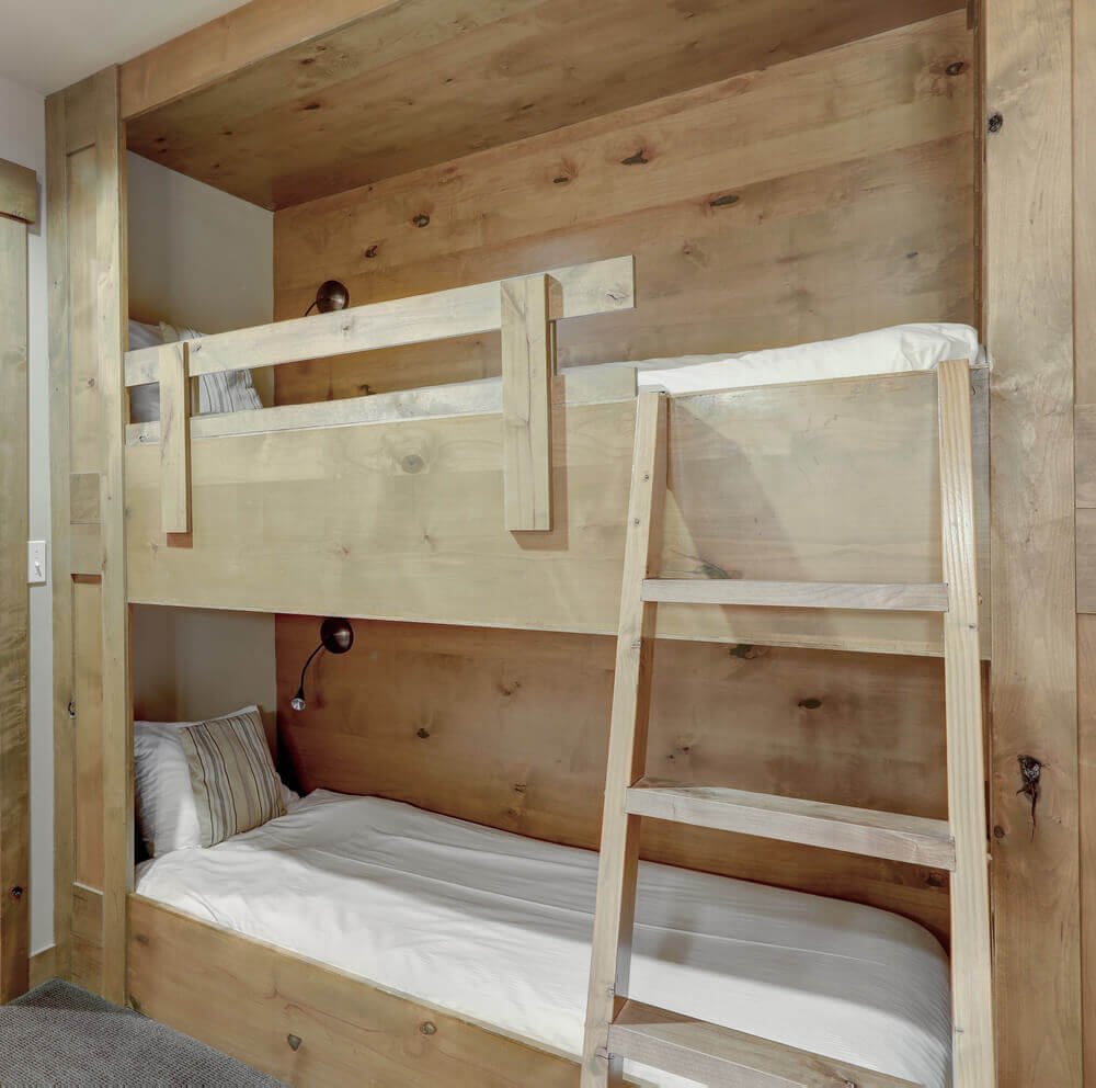 Bedroom with wooden bunk beds in a hallway for adults or kids 
